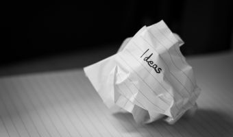 a crumpled up piece of paper with the word ideas written on it